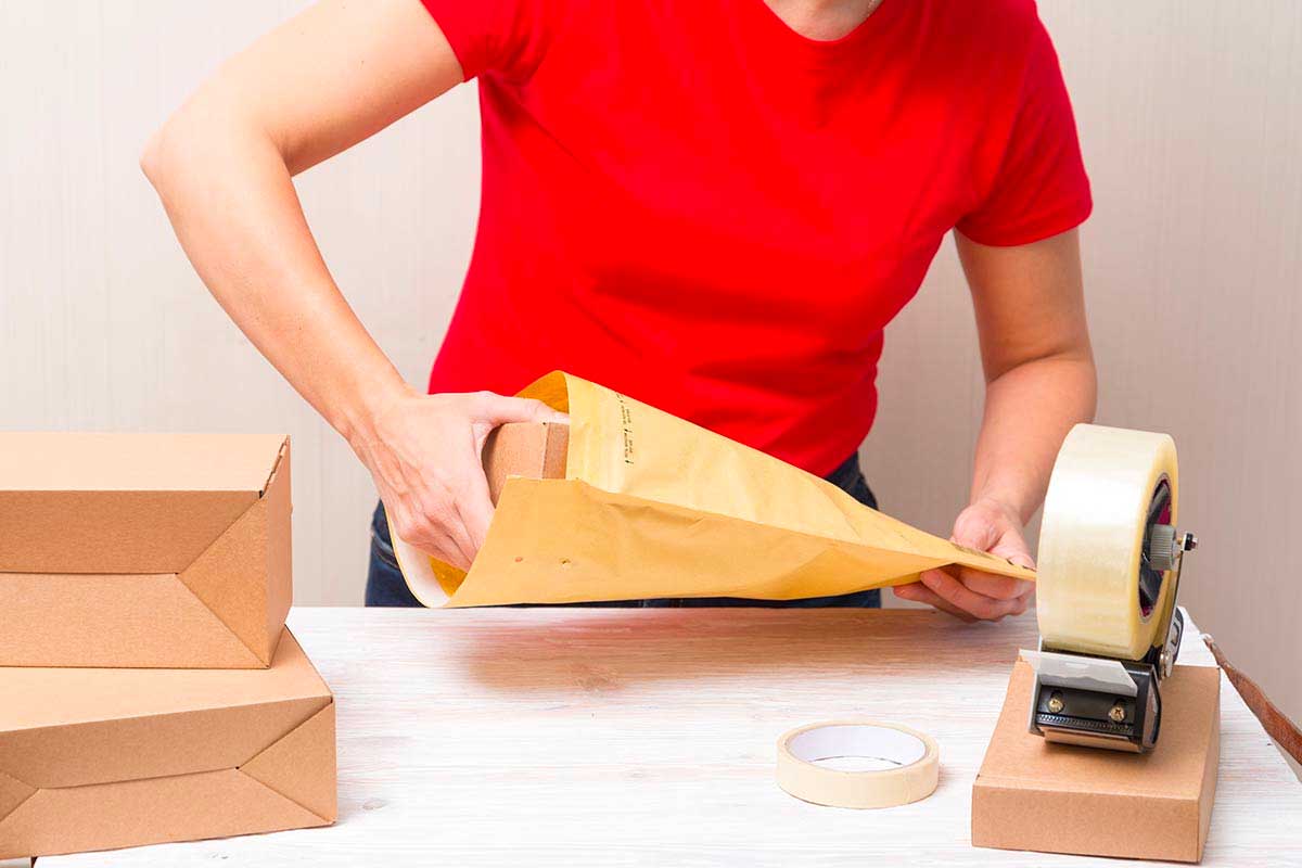Telebank Charity Fulfilment woman packing envelope in charity fulfilment service