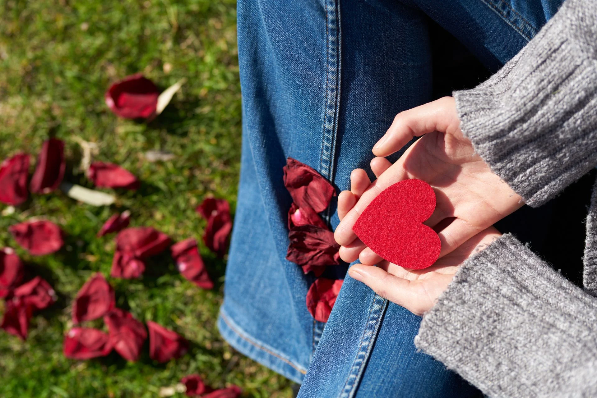 Hands holding a small red heart