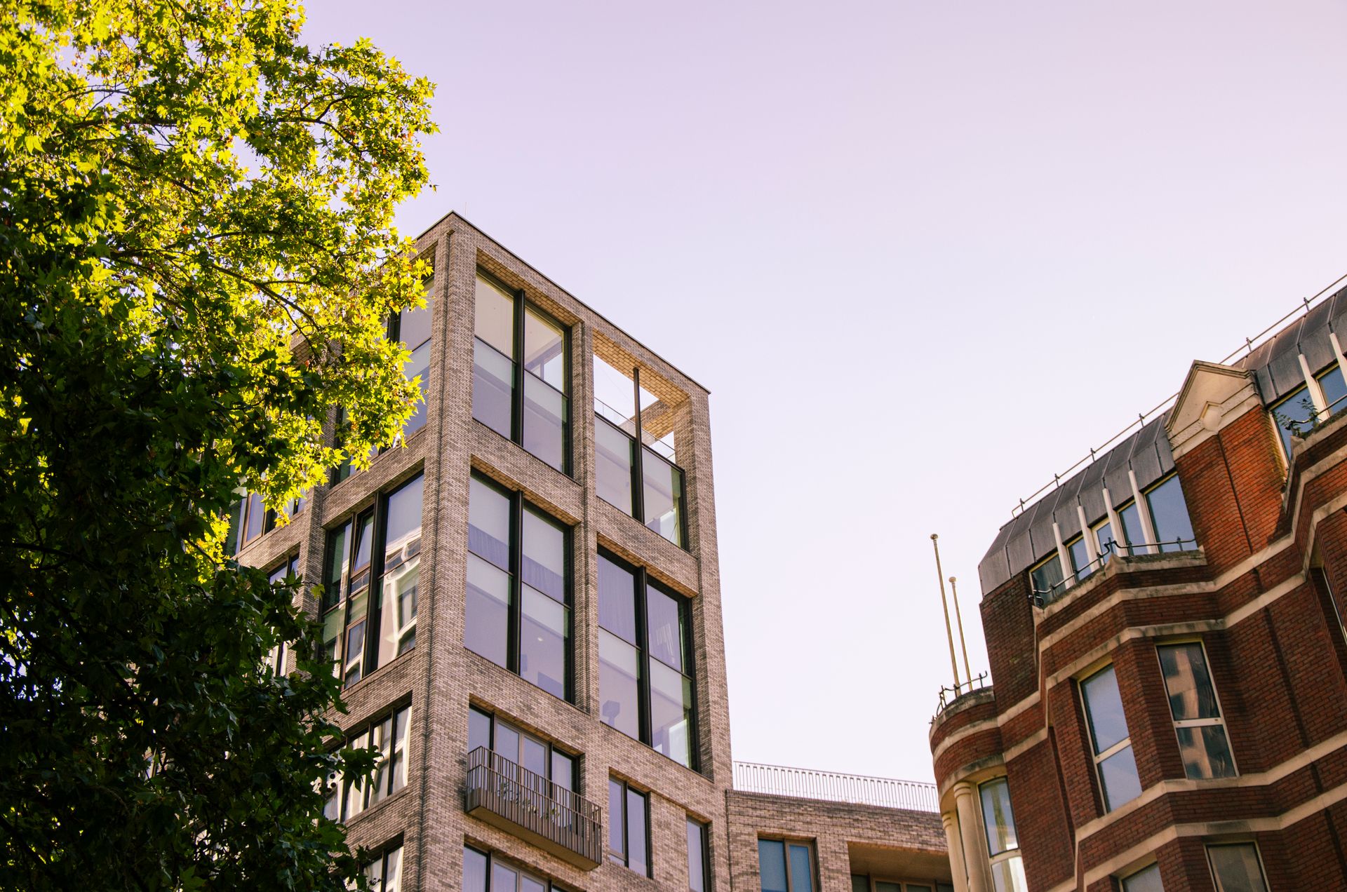 Architectural photo of modern buildings and trees in London, UK.