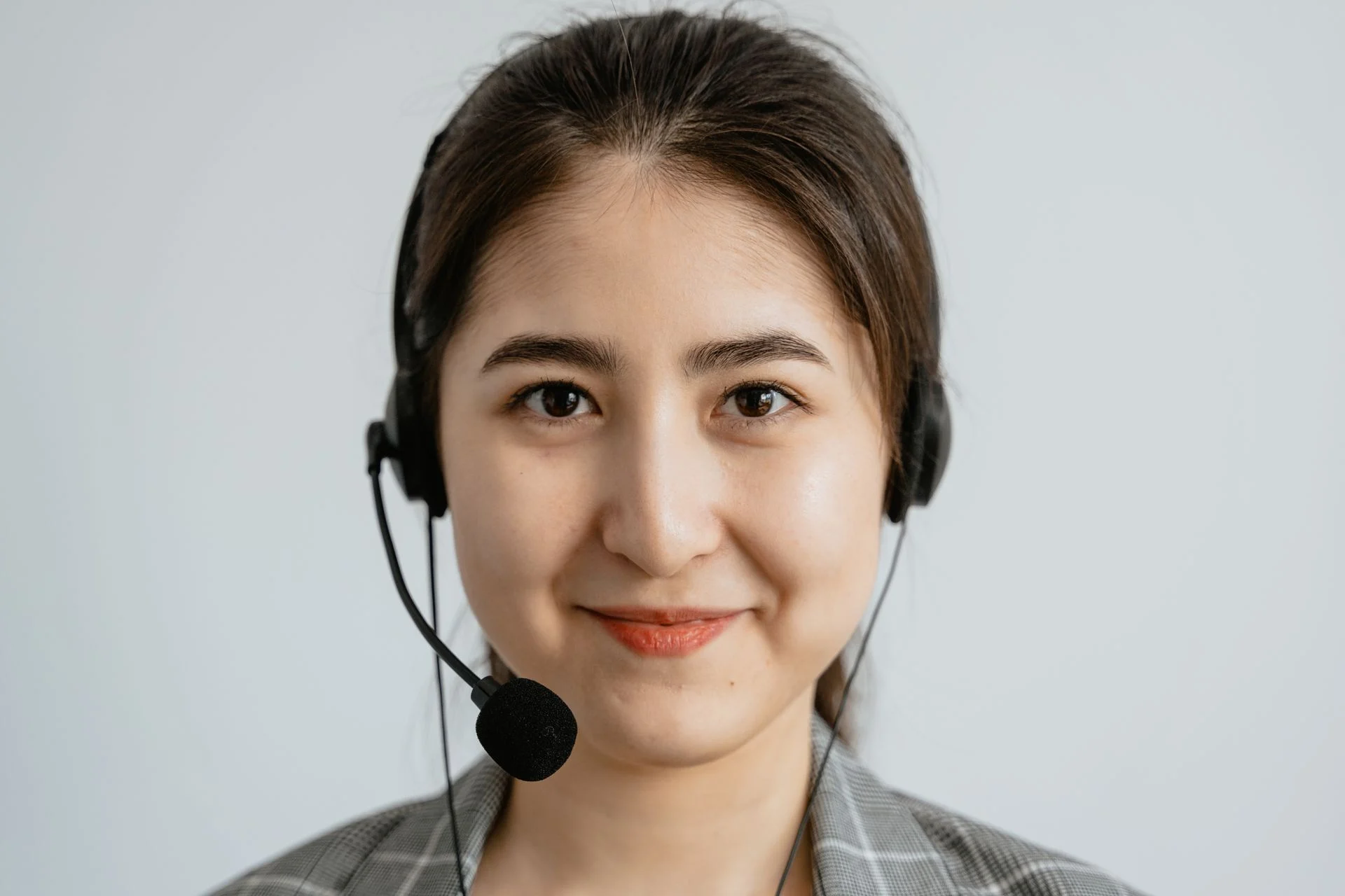 Supporter care adviser wearing a headset, smiling